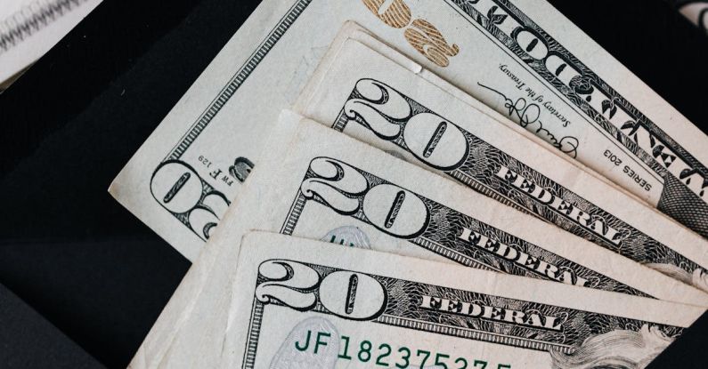 Growth Plan - Stack of dollars and black envelope with banknotes inside