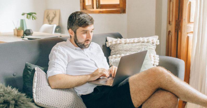 Remote Work - A Man Using a Laptop