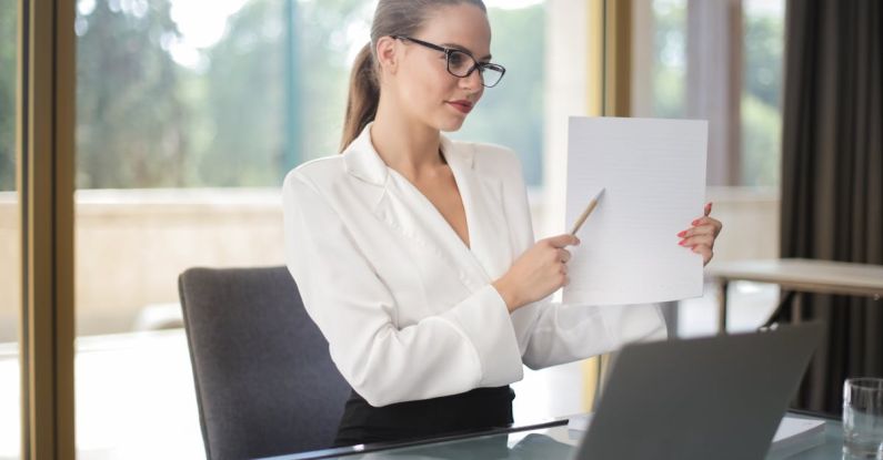 Wellness Plan - Determine female executive manager in formal wear sitting at table with laptop in office and explaining business plan